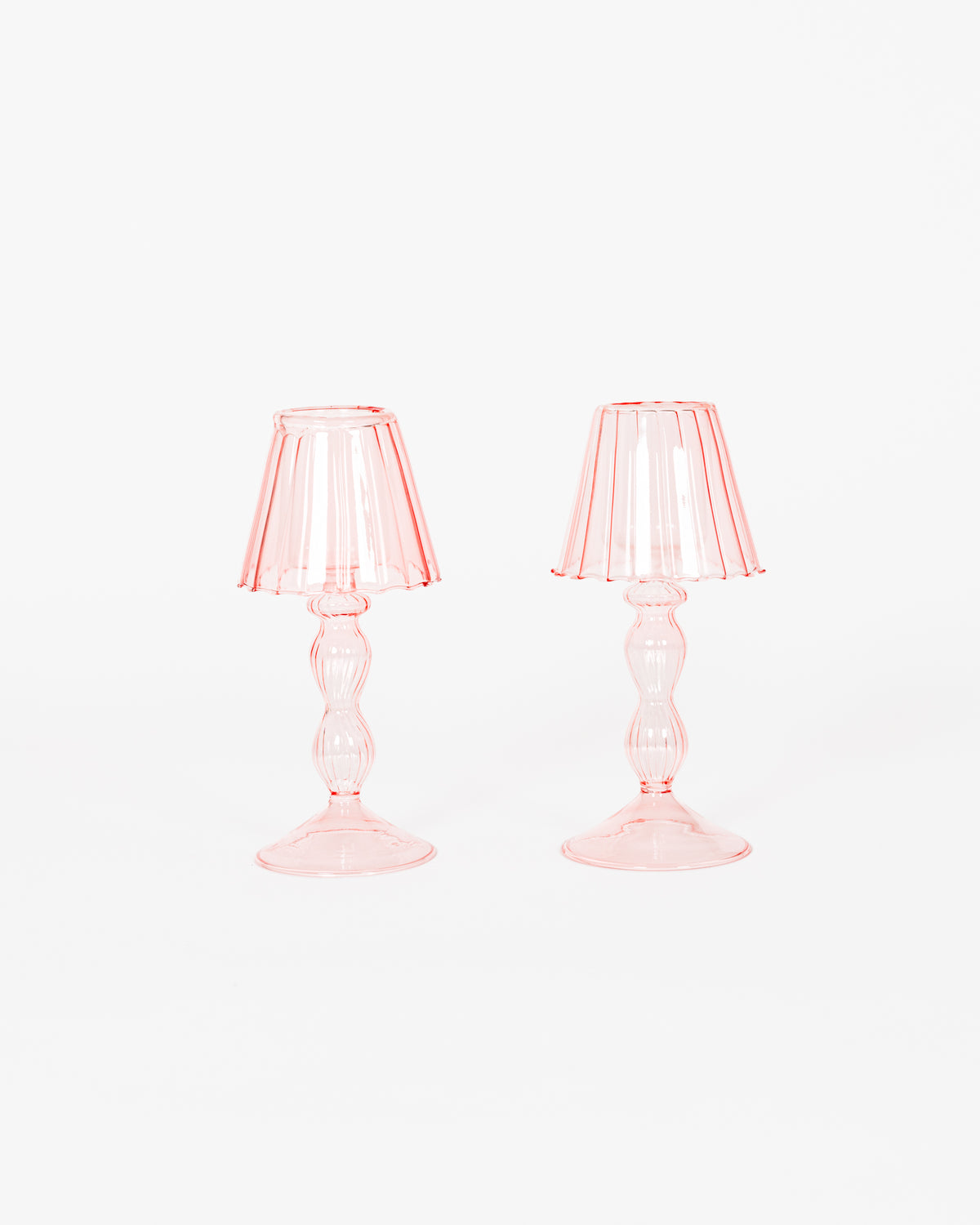 Pink glass lantern tea light holders, set of 2, on a dining table