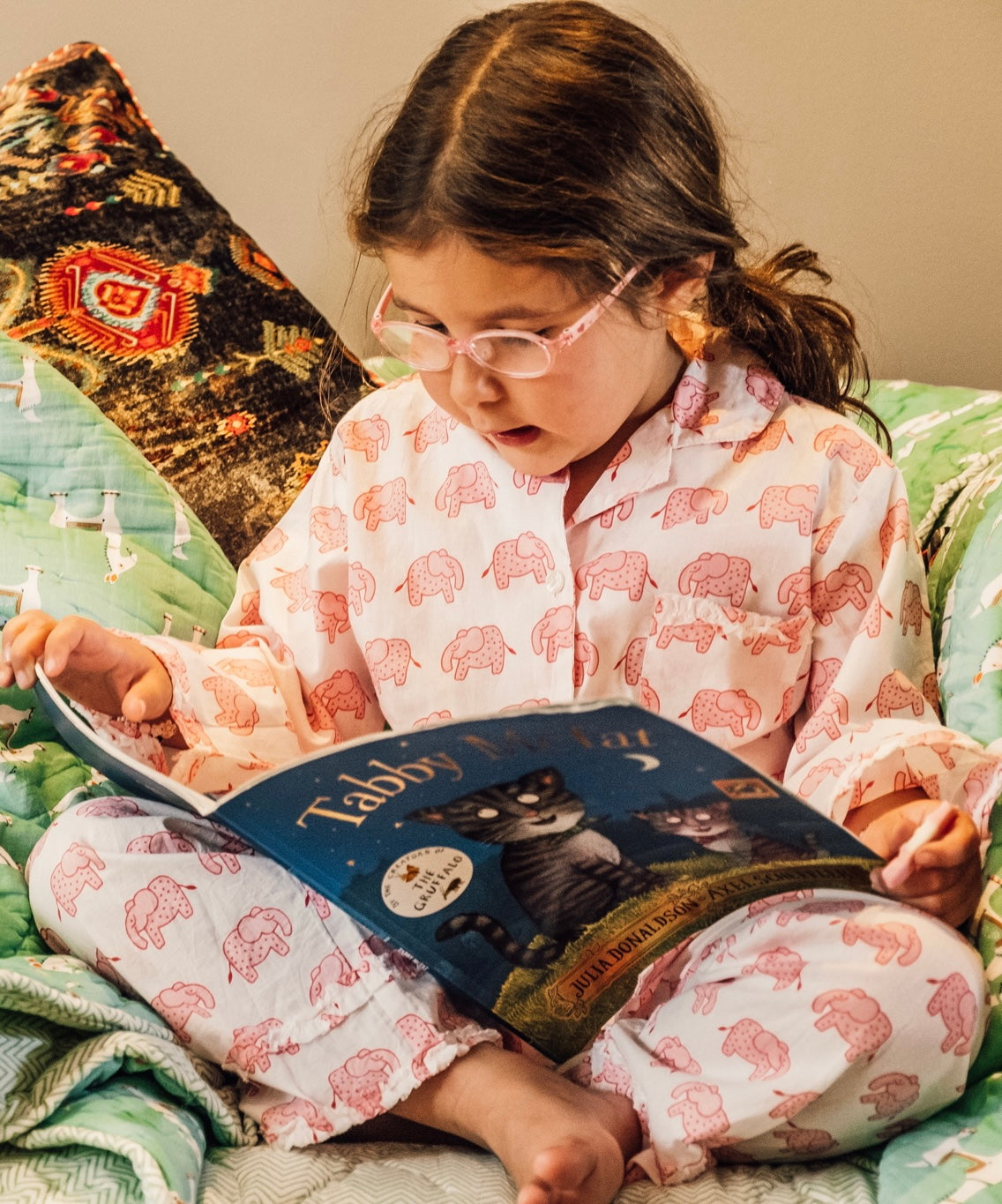 Girl wearing pink elephant print cotton pyjamas