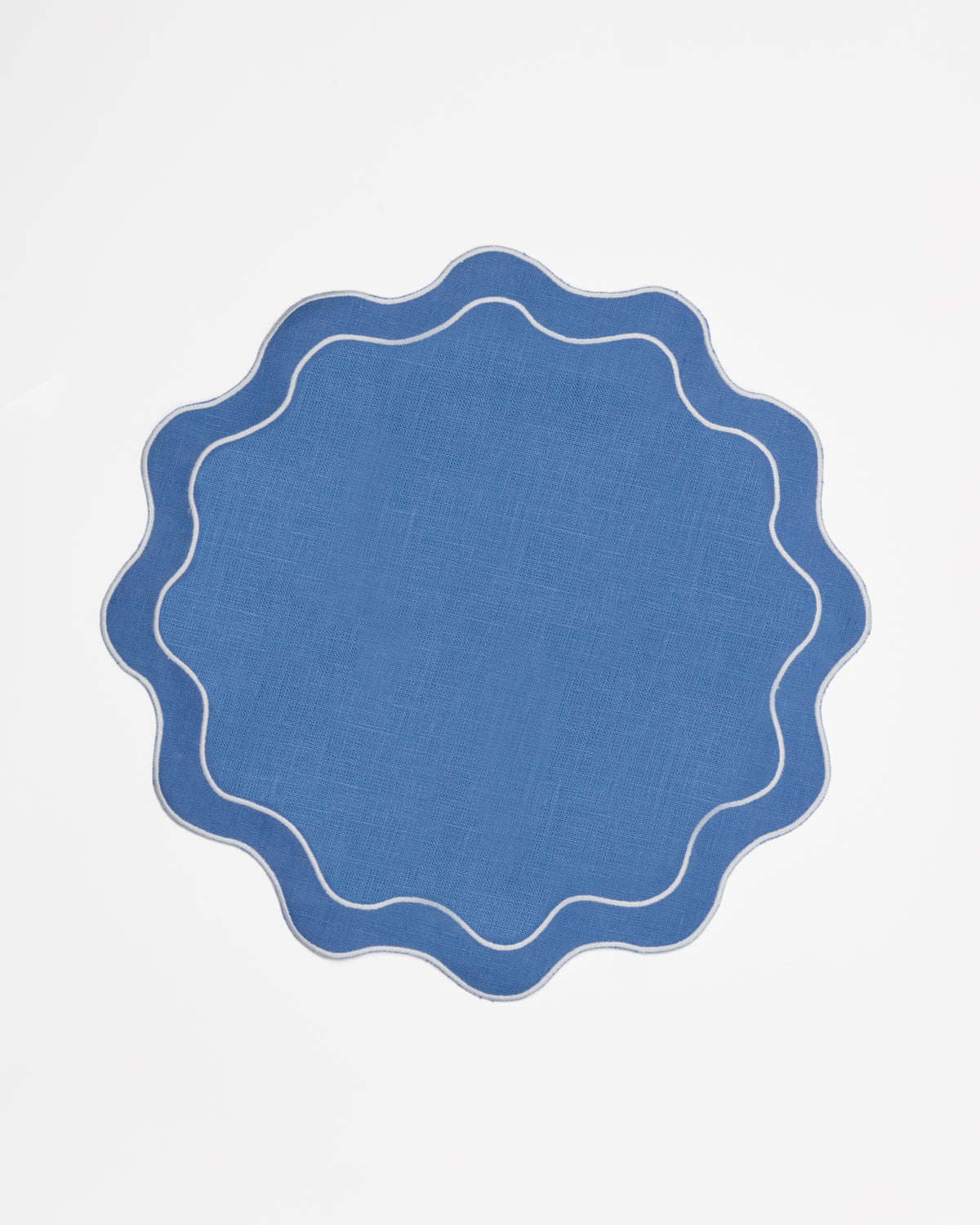 Round sky blue linen placemats with scalloped edges and white embroidered border, set of 2, by Rosie Dalia