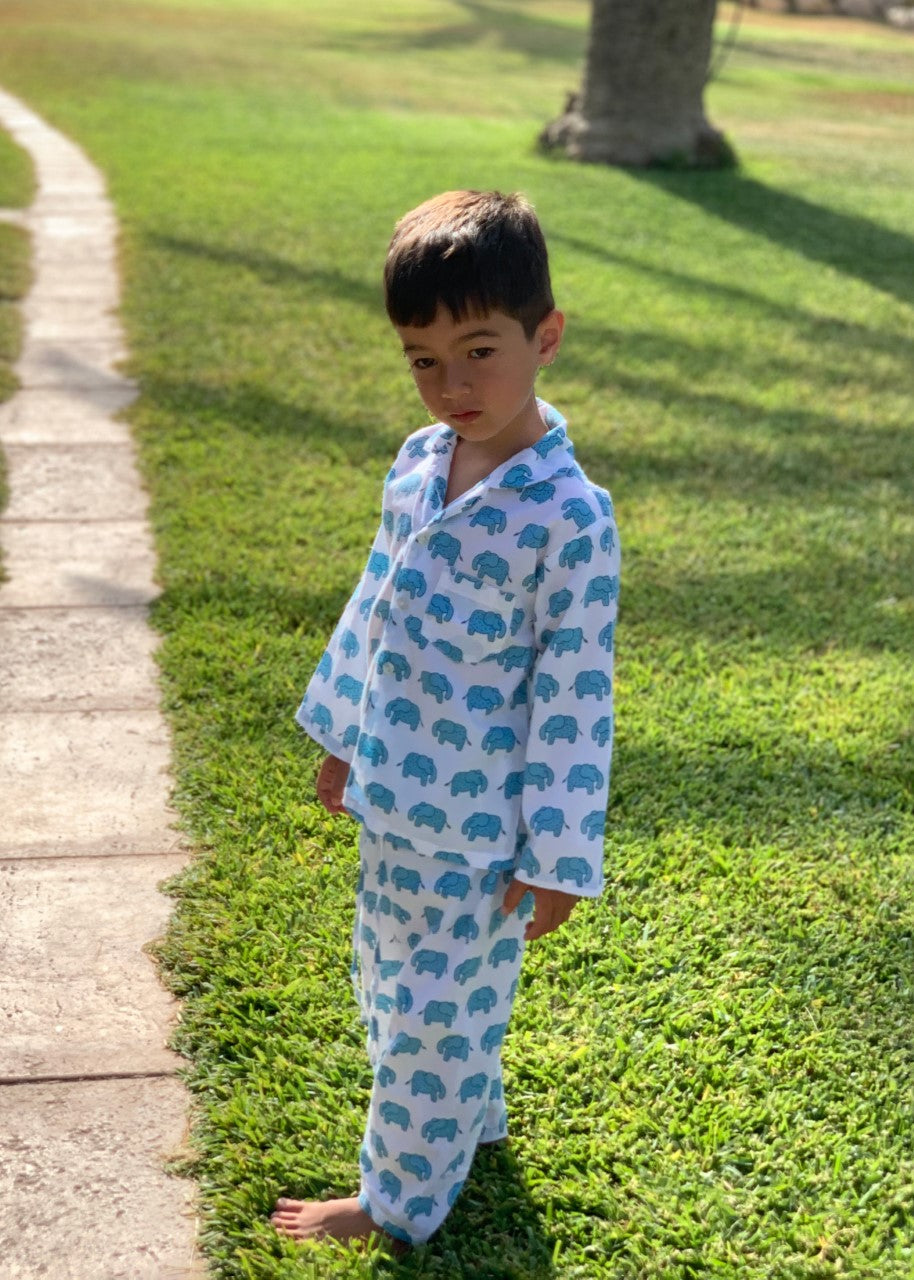 Boy wearing blue elephant print cotton pyjamas